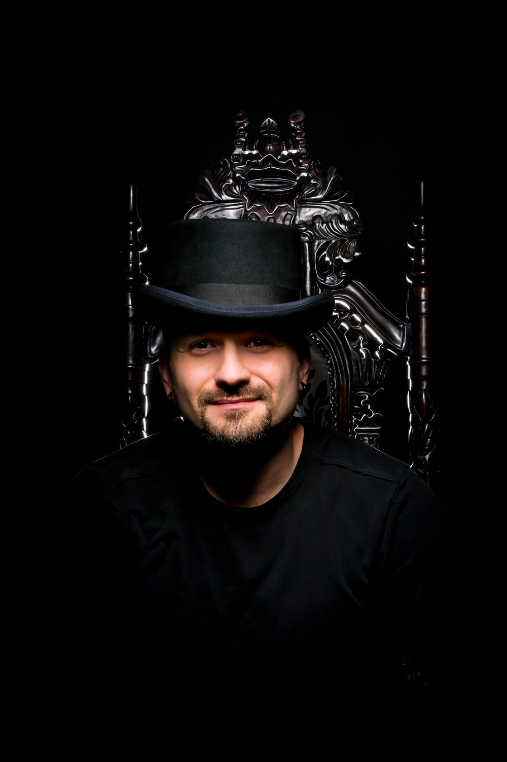 Arek Rainczuk, principal photographer at Five Castles Portraits, portrait on black