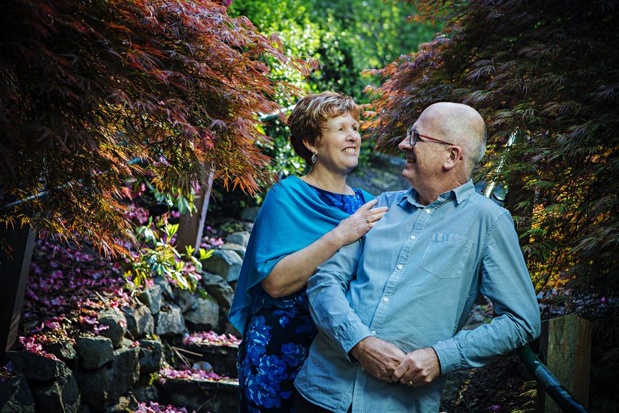 A couple framed inside a dead branch archway