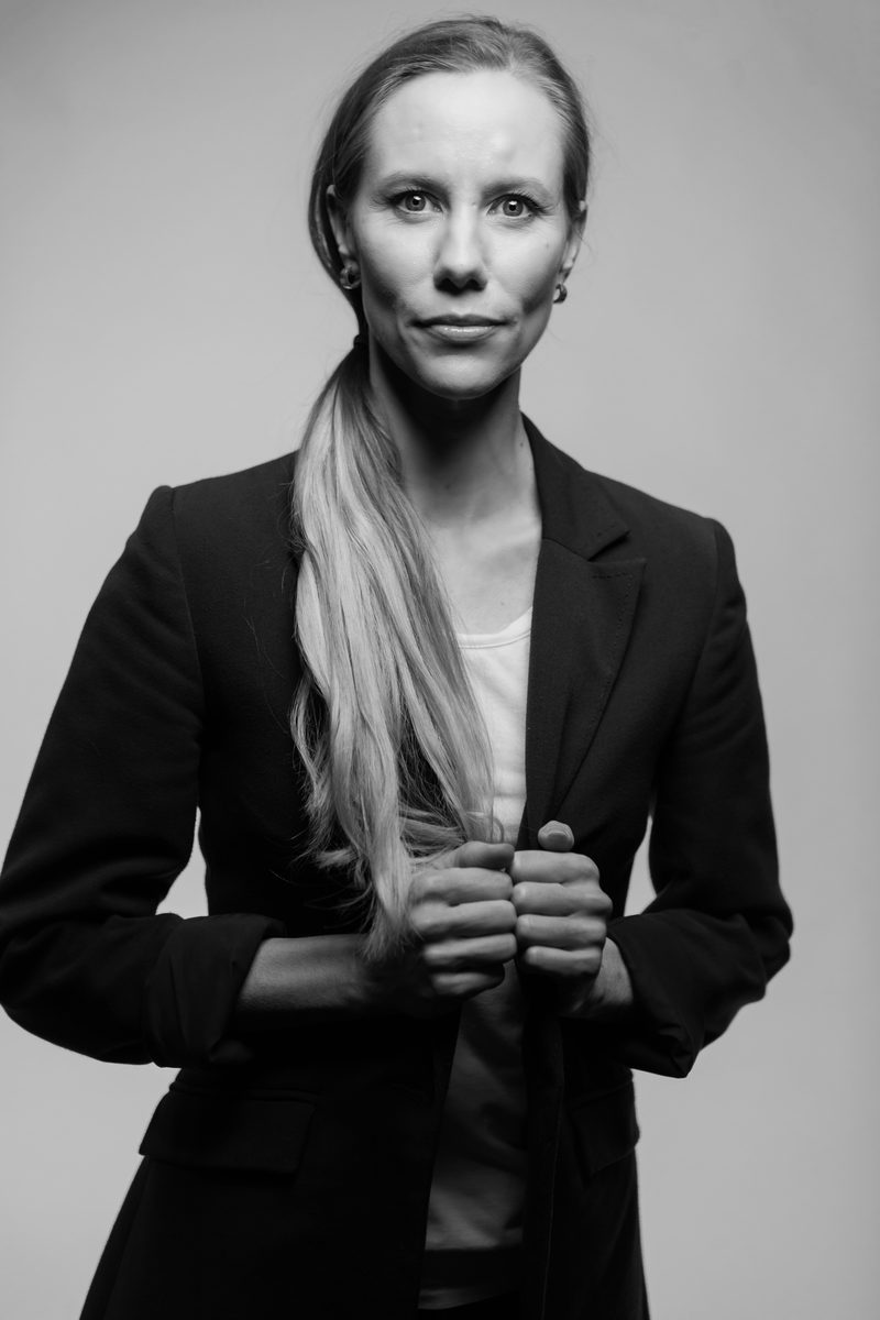 A monochrome personal branding portrait of a woman in a black blazer