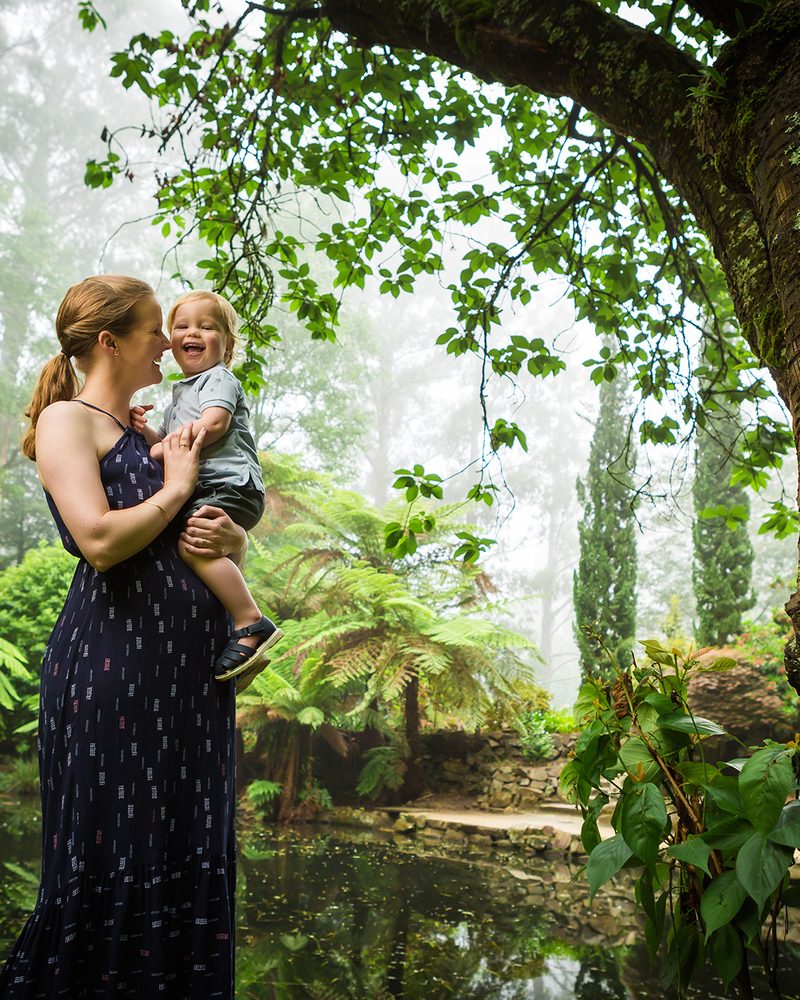 A maternity portrait at golden hour on a dramatic cliff edge