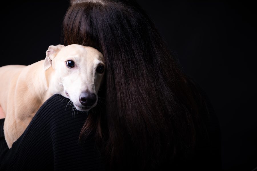 Studio portrait of a pet and its owner together with strong contrast
